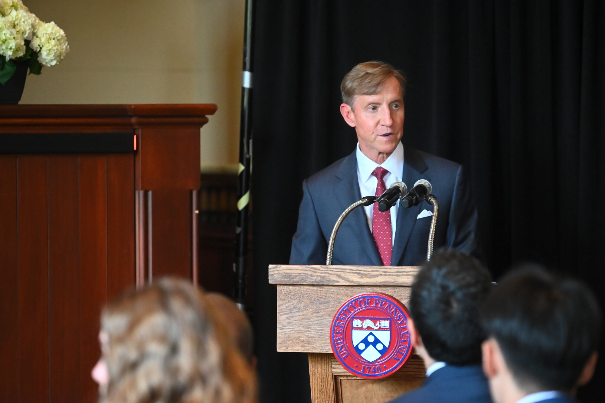 J. Larry Jameson speaking at the podium.