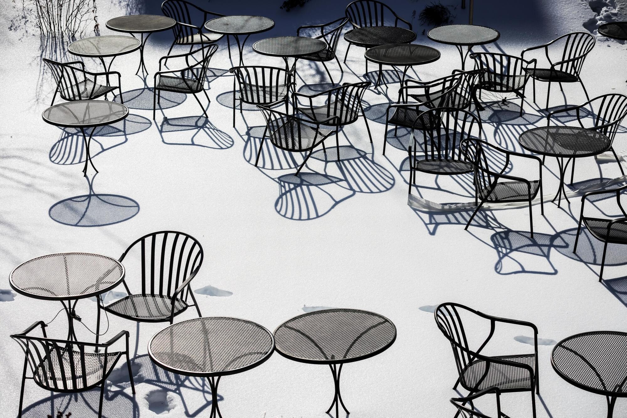 Outdoor chairs and tables in the snow.