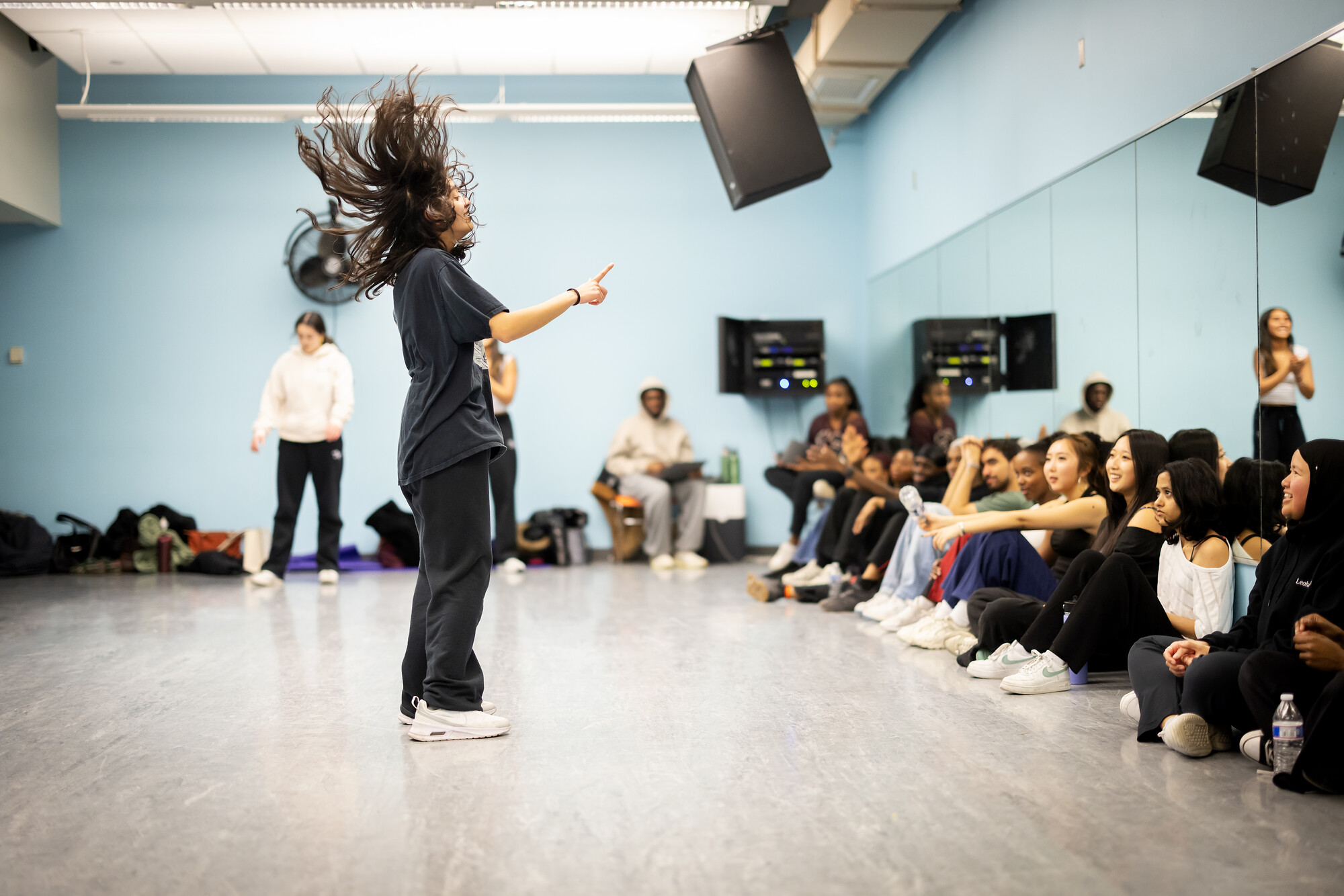 A performer with Strictly Funk standing and rehearsing.