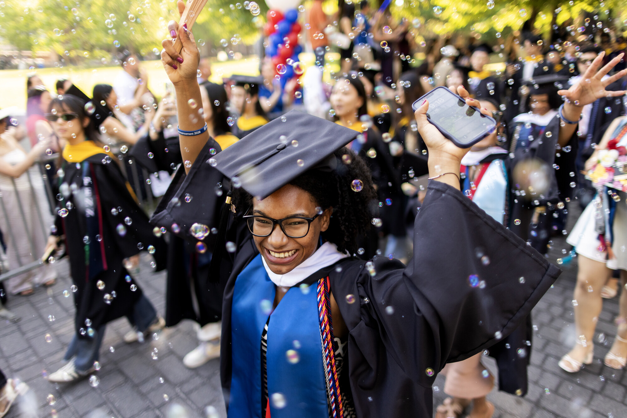 Graduates on Commencement on Locust Walk in regalia.