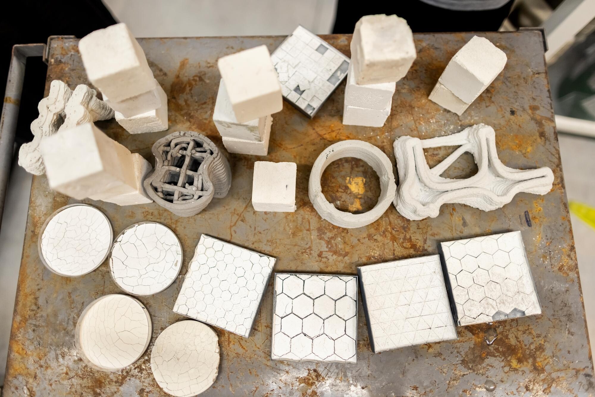 Overhead shot of a table displaying tiles of various textures and configurations. 