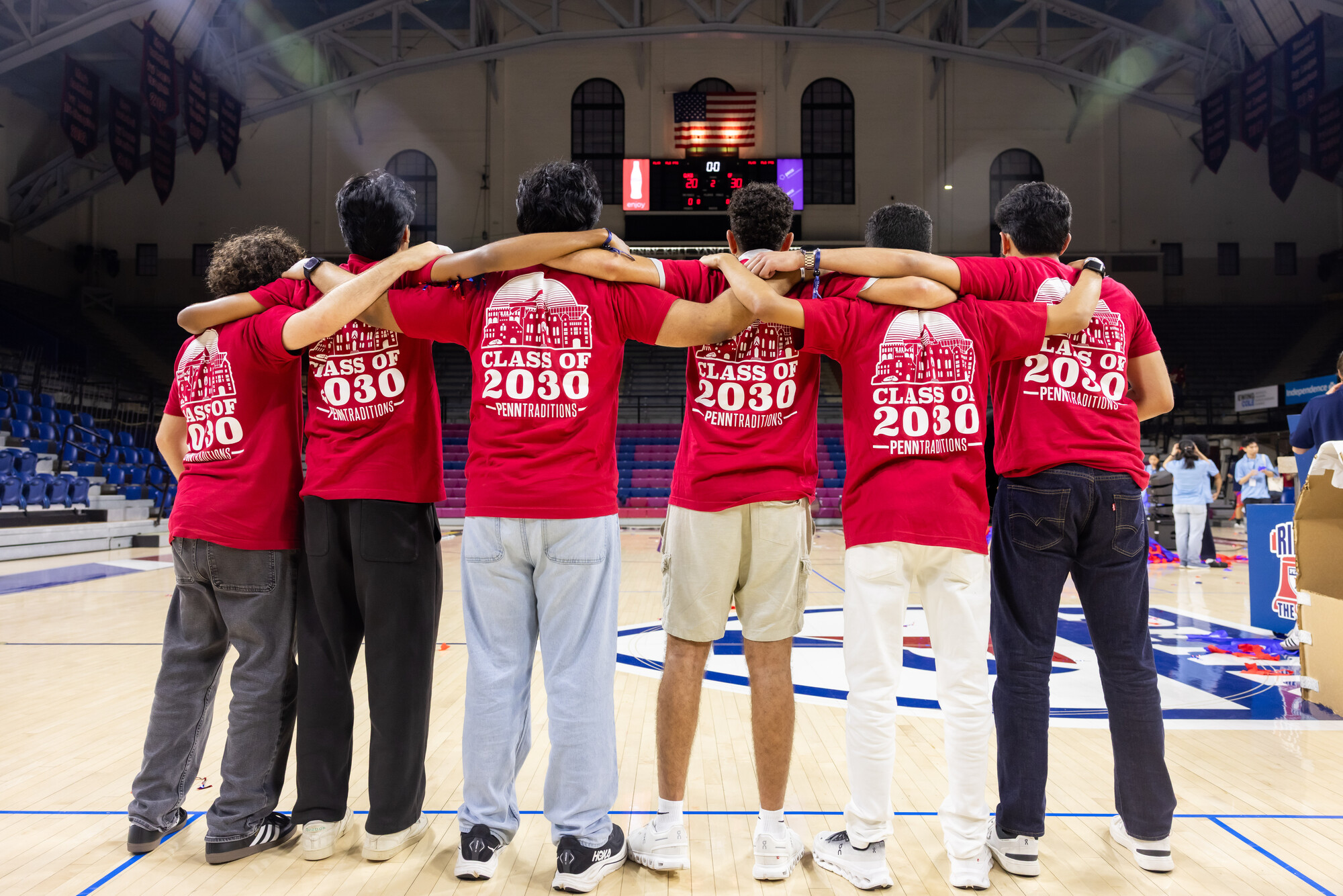Six members of the Class of 2030 in the Palestra with matching t-shirts.