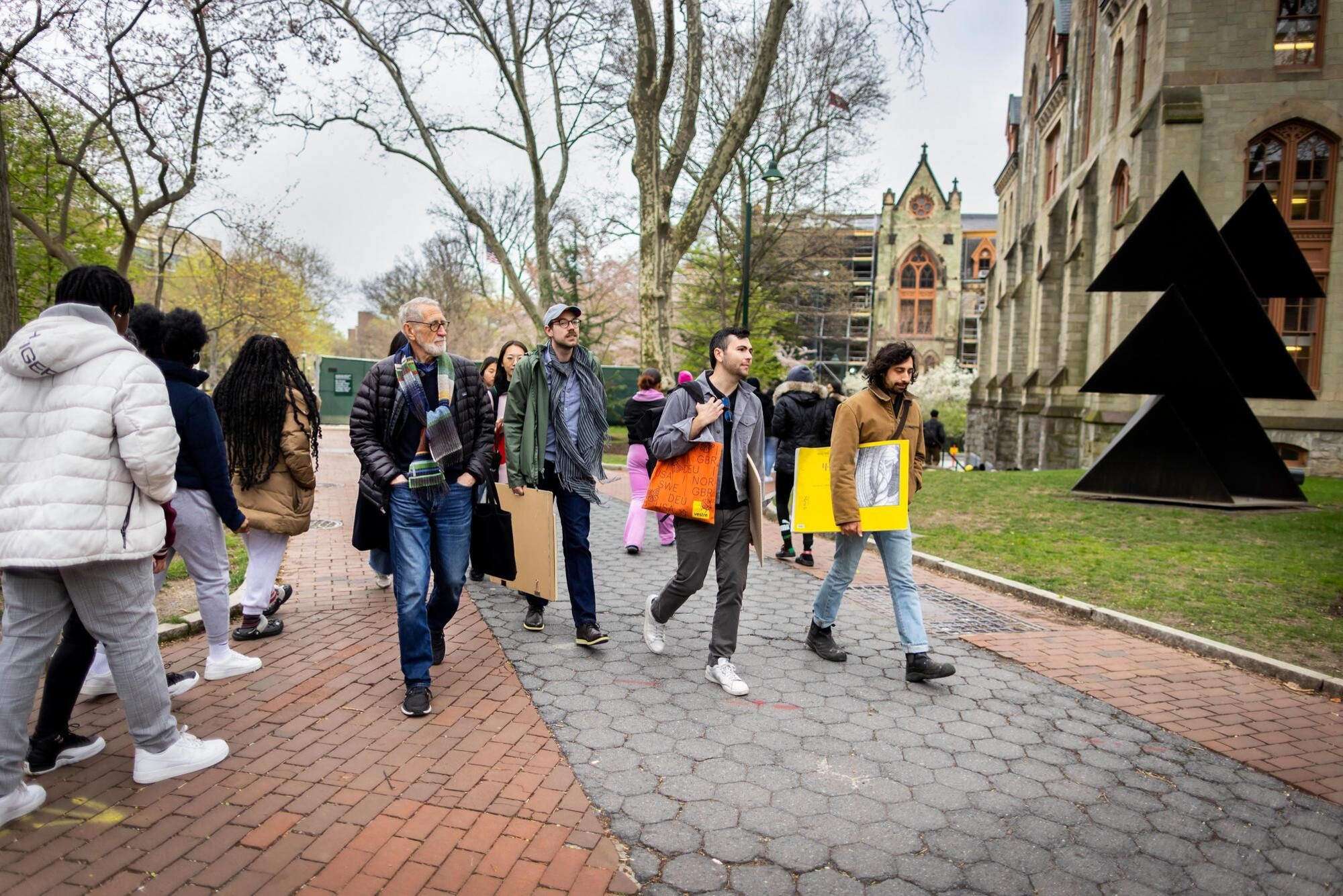Laurie Olin and students walking across the University of Pennsylvania's campus.