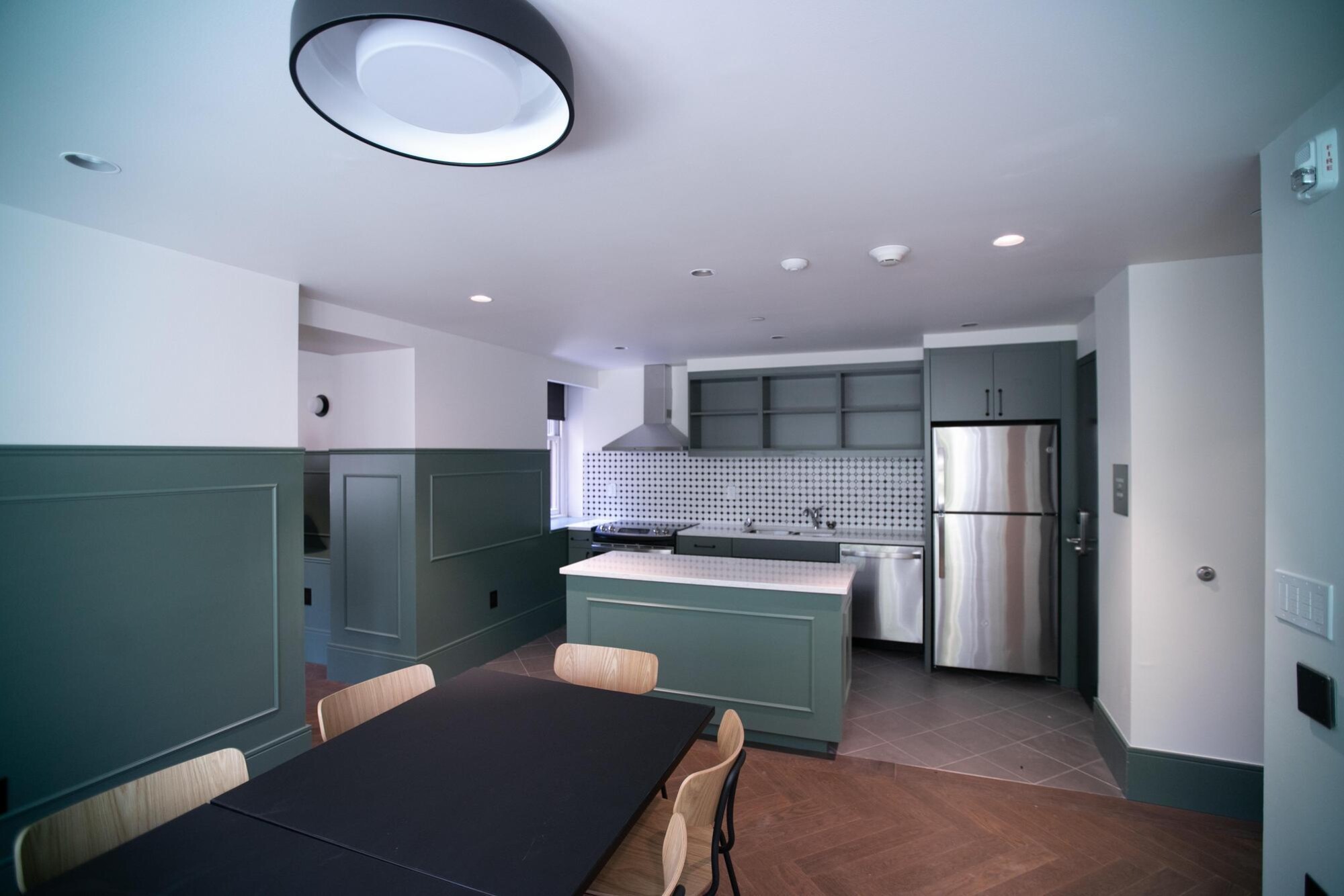 Kitchen with a table and overhead light.
