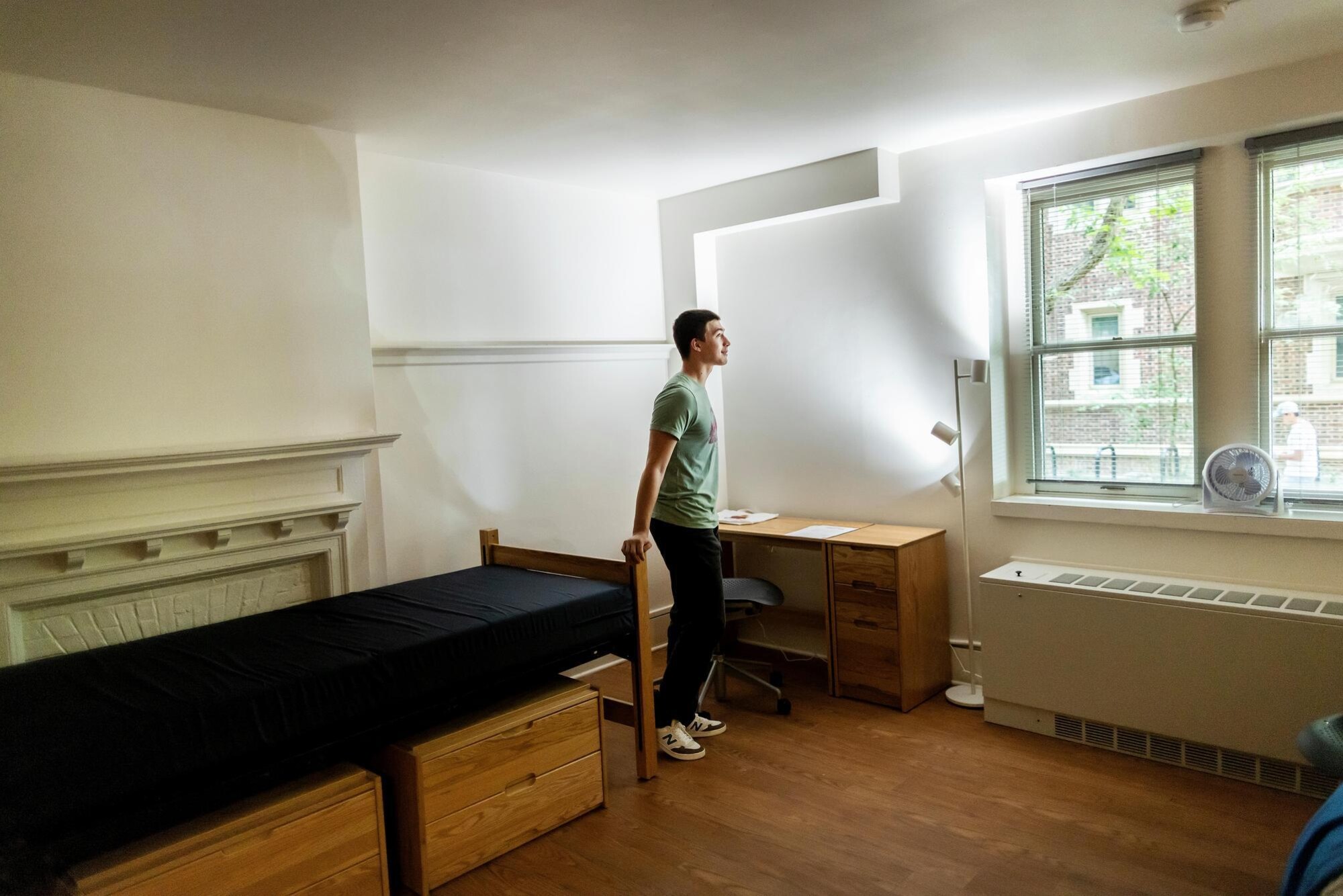 A student in their bare room in Penn’s Quad during Move-In.