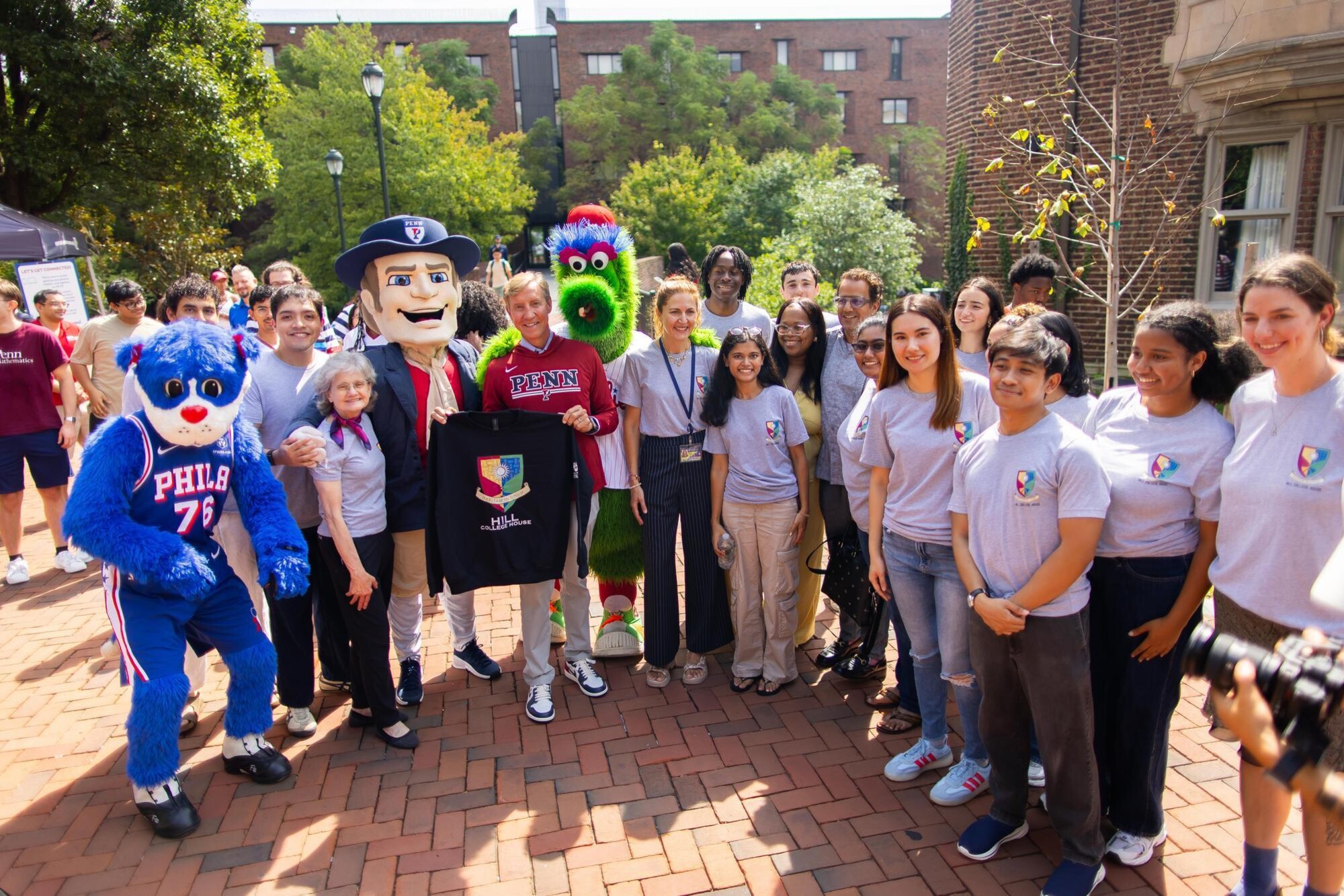 Penn President J. Larry Jameson, the Philly Phanatic, The Penn Quaker, Franklin the Dog, and Penn staff and students outside Hill House during Move-In.