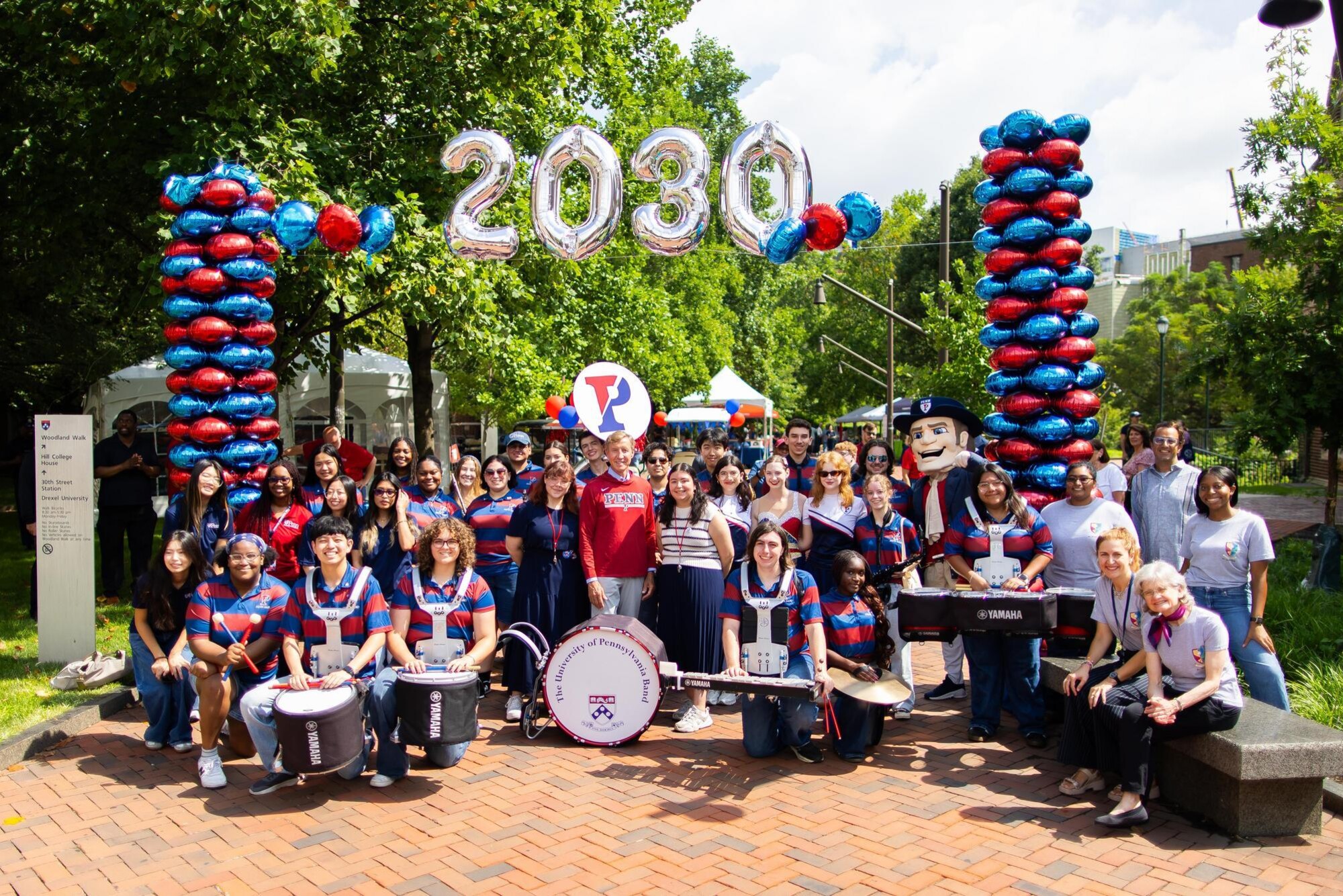 Penn President J. Larry Jameson and  members of the Penn Band under a 2030 balloon arch during Penn’s Move-In.