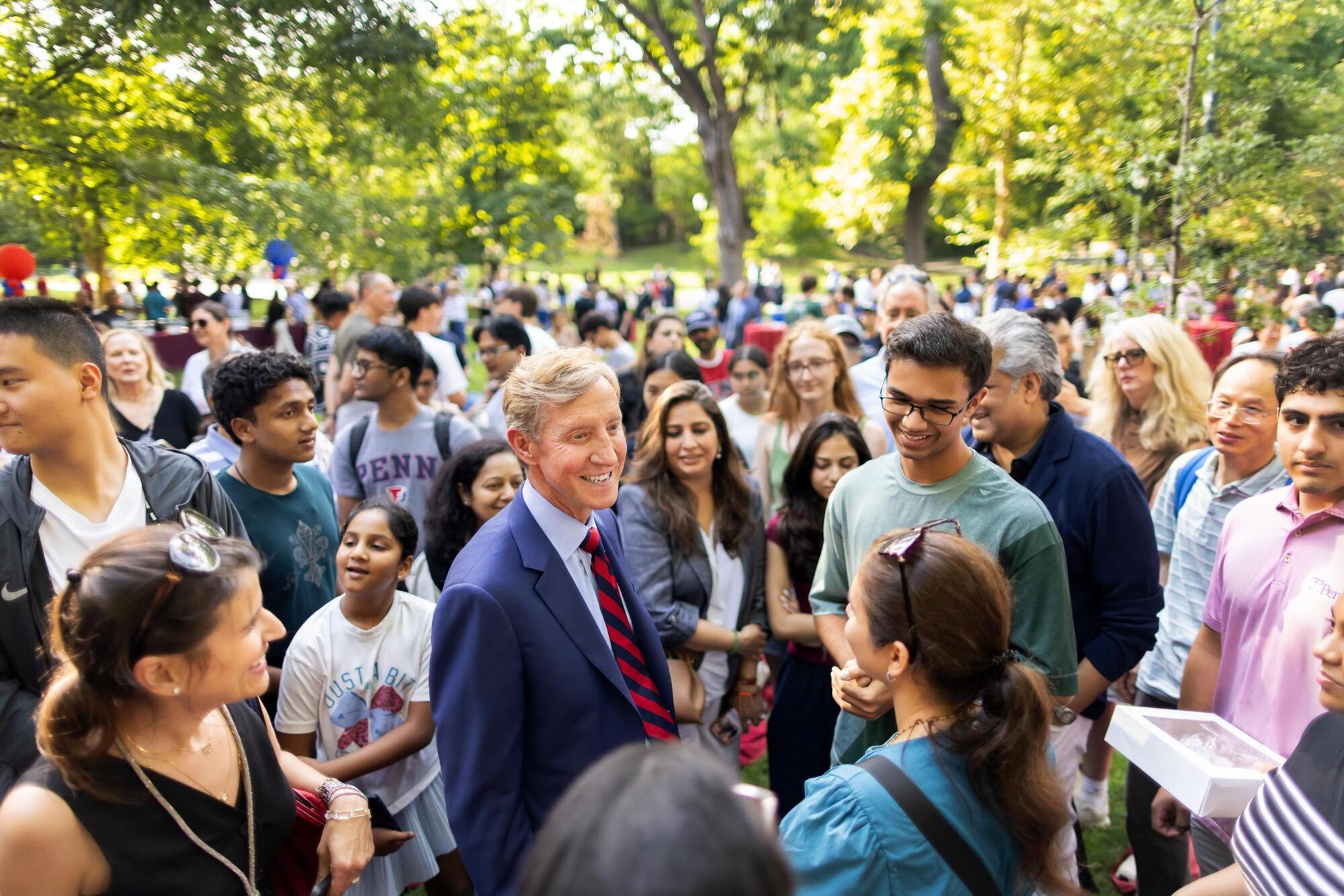 Penn President J. Larry Jameson meeting families on College Green.