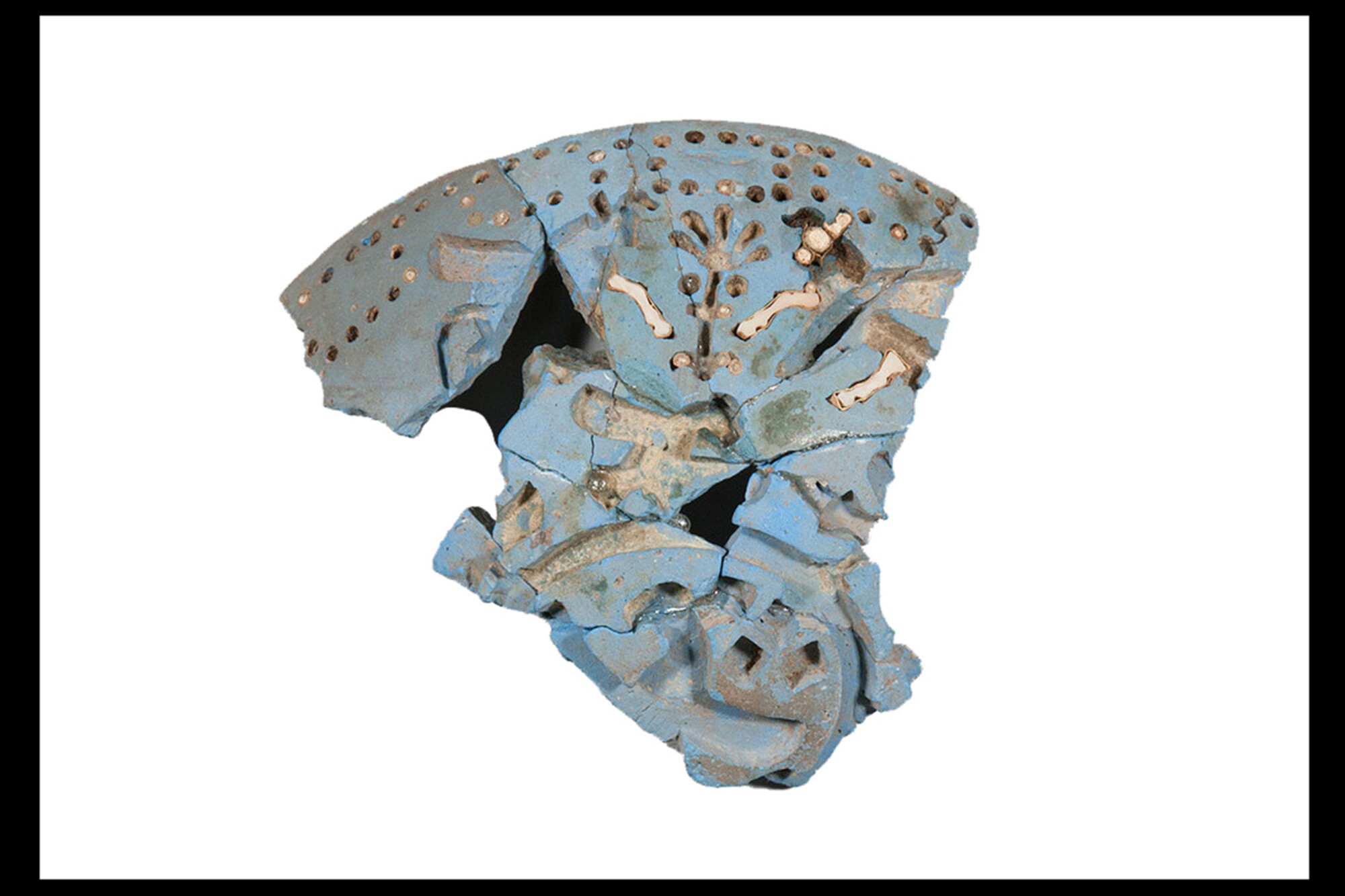 A shard of an ancient egyptian blue bowl with gold.