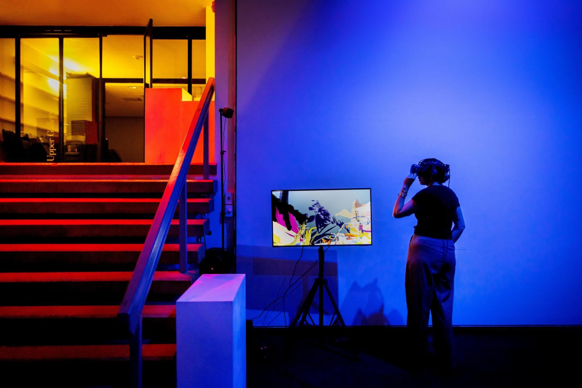 Person views virtual reality experience in gallery.