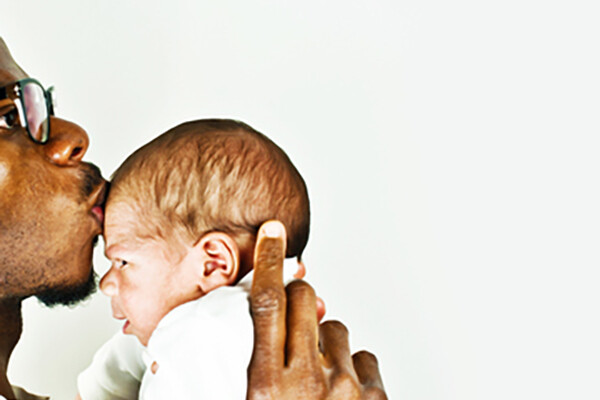 father-kissing-newborn-son-on-head