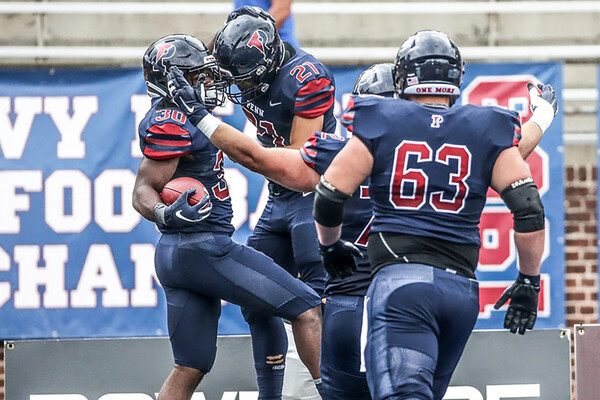 Football players celebrate in end zone after touchdown