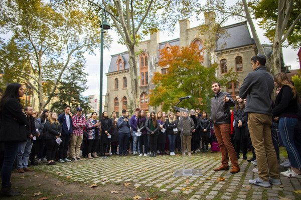 the vigil crowd standing in front of College Hall on Penn campus