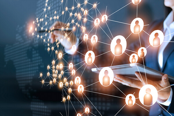 business woman making connections on a screen while holding an ipad