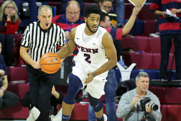 Antonio Woods dribbles down the court