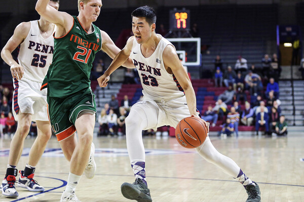 Michael Wang dribbles to the basketball versus Miami