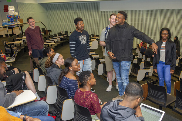 Cope in front of students in class