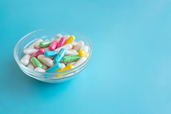 Glass bowl of multi-colored gel caps