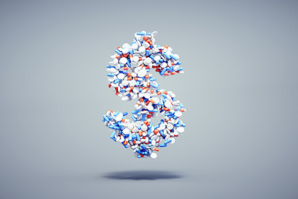 Dollar sign made of many prescription pills.