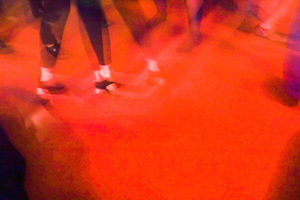 Legs and heels in a fog of red