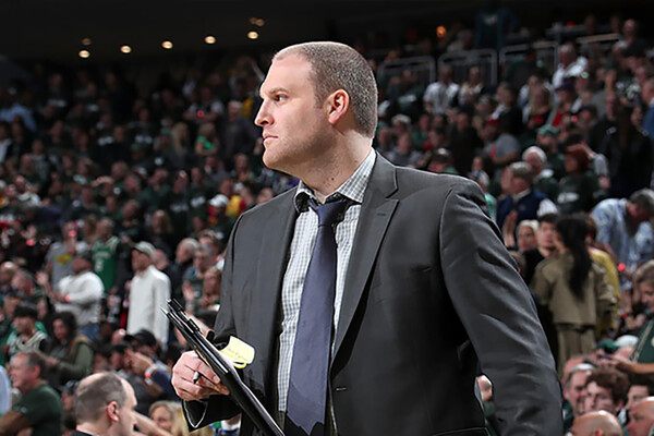 Taylor Jenkins, the new coach of the Memphis Grizzlies, holds a clipboard while coaching a game.