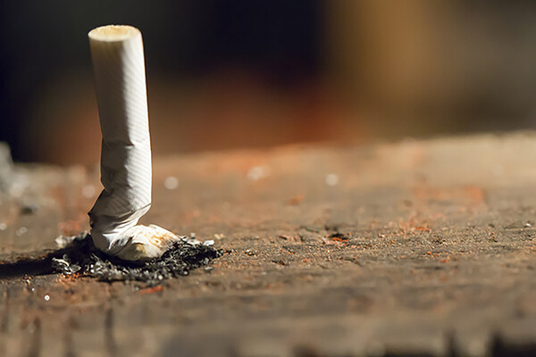 crushed cigarette butt vertical on the ground