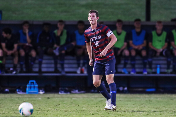 Alex Touche, captain of the men's soccer team, prepares to strike the ball.