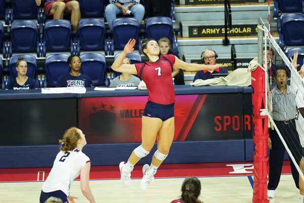 At the Palestra, Parker Jones jumps in the air and prepares to strike the ball.