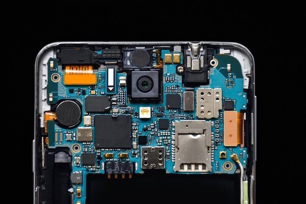 the back of an open phone showing chips and circuits