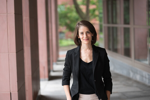 Julia Ticona smiles with her hands in her pockets