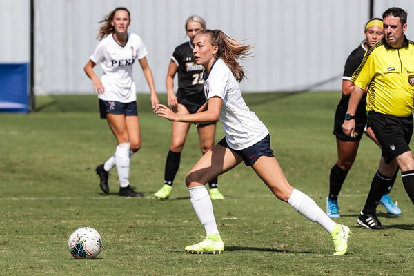 Breukelen Woodard of the women's soccer team kicks the ball down the field against Towson.