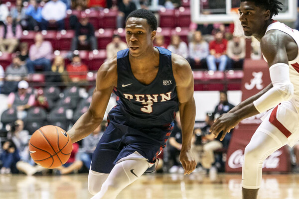 Dribbling the basketball, freshman Jordan Dingle drives to the basket during an away game at Alabama.