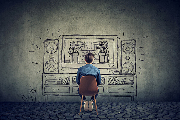 person in sparse room sits in chair facing a wall with a cartoon drawing of a televised political debate