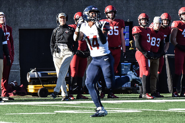 Wide receiver Rory Starkey, Jr., a sophomore, prepares to catch a ball with his arms outstretched against Harvard.