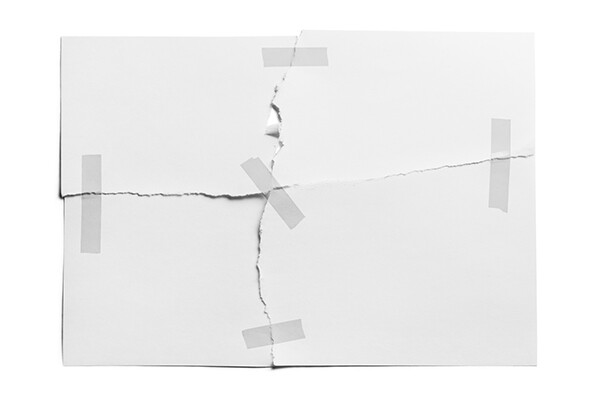 torn piece of paper pieced back together and held together with adhesive tape.