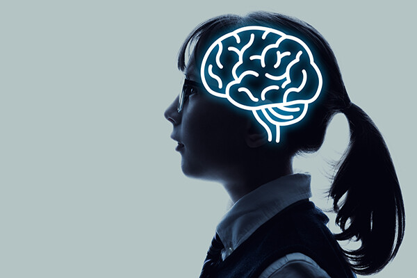 adolescent in profile wearing glasses with a ponytail, a highlighted outline of their brain hemisphere superimposed over the side of their head.