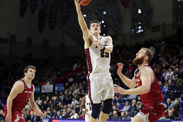 AJ Brodeur shoots a basket on court during a game