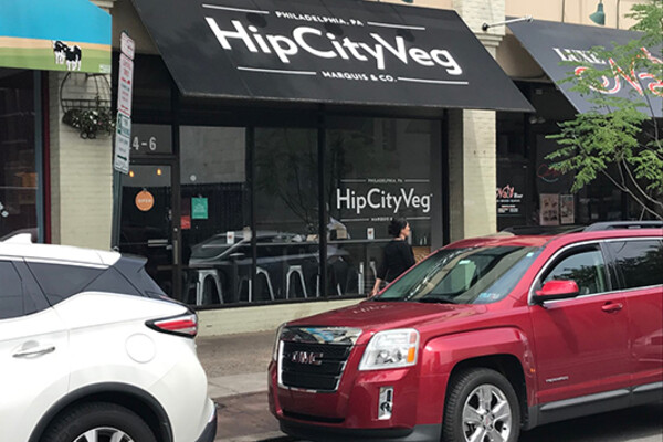 View of facade and awning for HipCityVeg on 40th St in daylight.