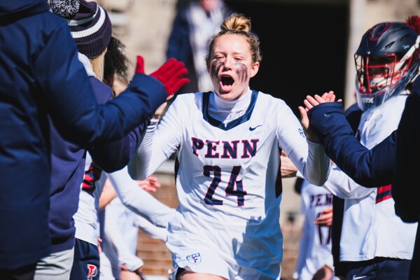 At Franklin Field, Gabby Rosenzweig takes the field and high-fives her teammates during pregame introductions.