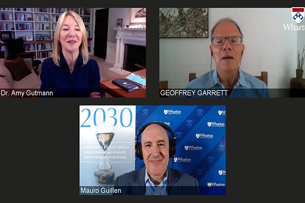 Screen shot of a Zoom screen with Amy Gutmann, Geoffrey Garrett and Mauro Guillen