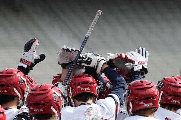 Players raise their hands above their heads and put them together in a huddle.