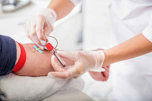 Needle sticking into arm of patient