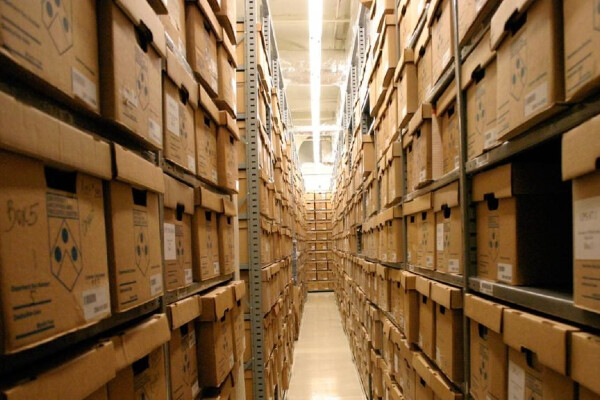 a tall aisle of cardboard boxes