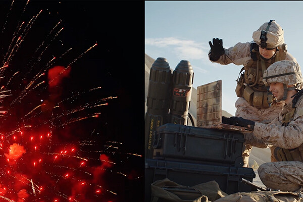 On the left side of the screen, fireworks in the night sky, on the right, two military members in combat gear in front of an explosive device.