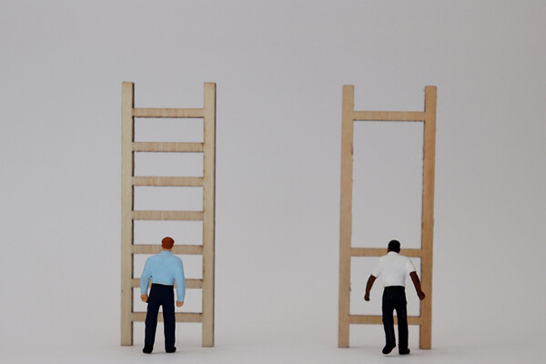 white man in front of ladder next to Black man in front of ladder missing rungs