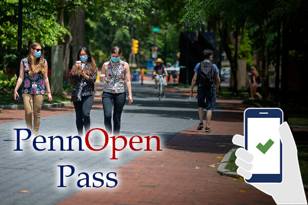 a group of people walking outside on campus while wearing masks
