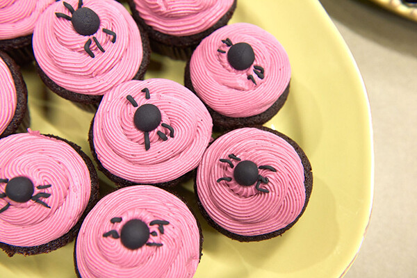 Plate of pink frosted cupcakes.