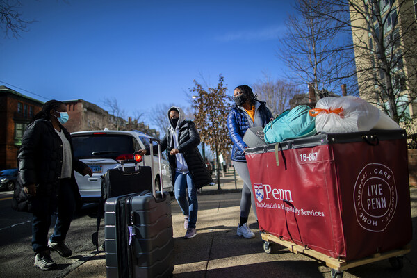 students with carts moving in at the quad