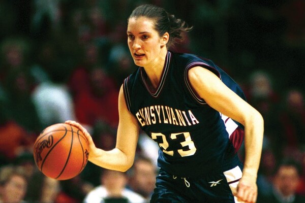Wearing a a blue Penn jersey with number 23, Diana Caramanico dribbles the ball up the court.