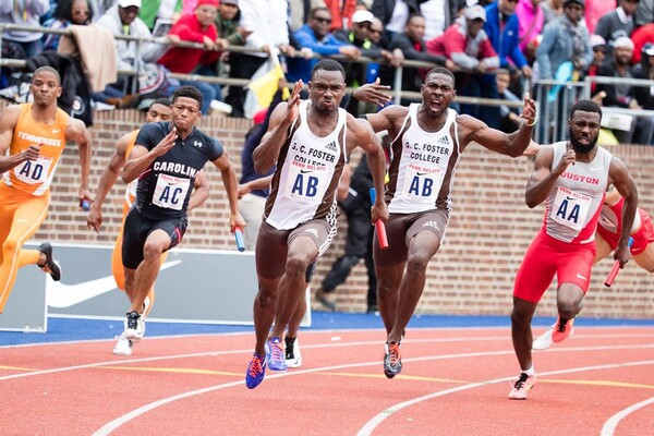 College athletes race around Franklin Field during relay race at the Penn Relays in pre-pandemic times.